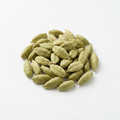 Whole green elaichi cardamom pods on a white background