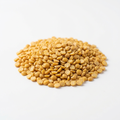 Golden yellow dry split pigeon peas on a white background