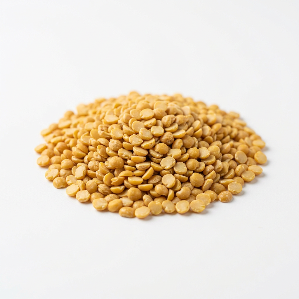 Golden yellow dry split pigeon peas on a white background